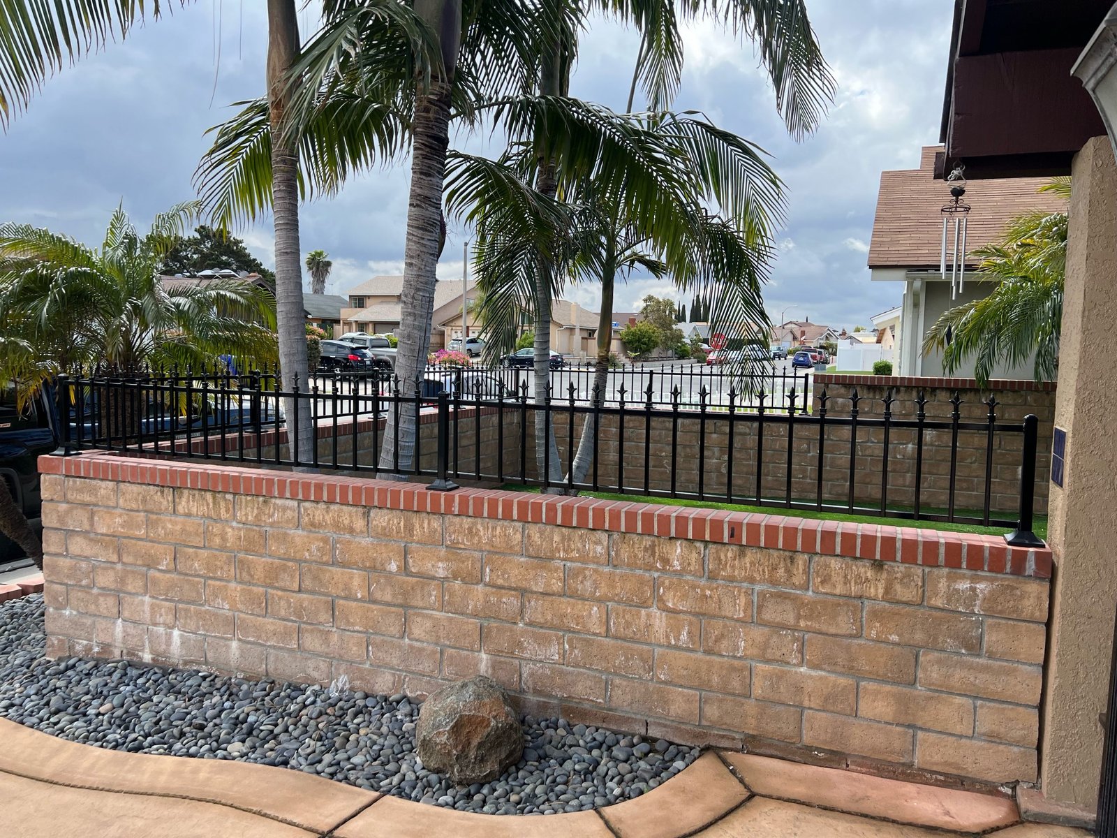 Iron fence topper installed on a block wall