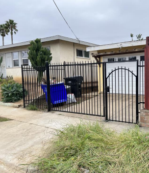 Driveway gate with arched pedestrian gate