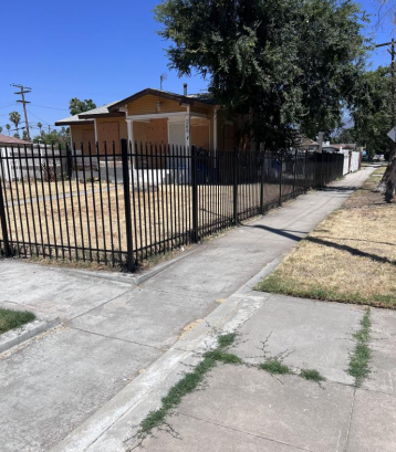 Iron security fence along a sidewalk
